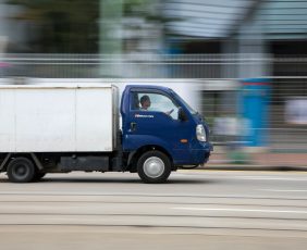 blue and white van on road during daytime